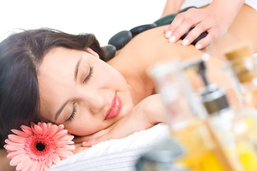 Pretty woman enjoys massage in the spa salon