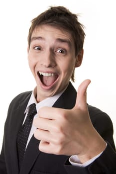 Portrait of amazed businessman with open mouth keeping his thumb up