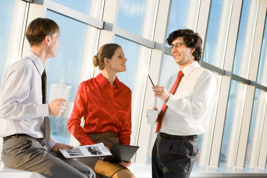 Portrait of businessman explaining new project to his colleagues