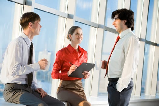 Portrait of three business people discussing new project at meeting