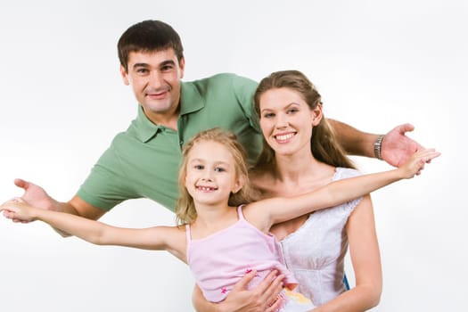 Portrait of playful girl with father and mother touching her