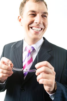 Portrait of happy businessman looking aside with glasses in hands
