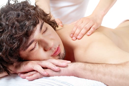 Portrait of calm guy enjoying the procedure of massage
