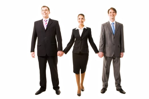 Team of three business people holding each other by hands