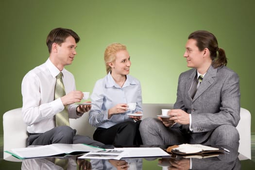 Portrait of business team having coffee break and chatting with each other