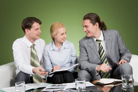 Photo of confident business people communicating at meeting