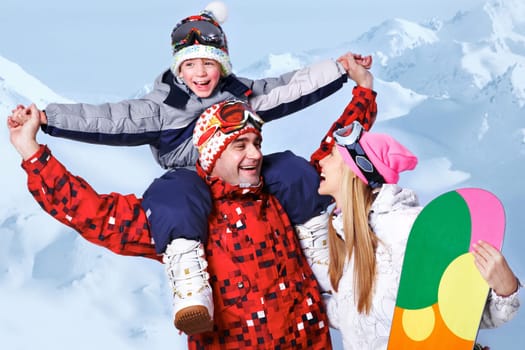 Portrait of happy family with snowboards having fun on winter resort