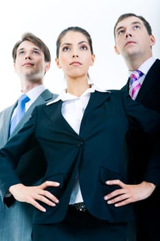 Portrait of three confident business partners looking forward with serious faces