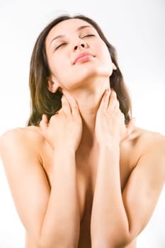 Portrait of nude pretty woman touching her neck
