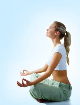 Profile of woman meditating in pose of lotus in isolation