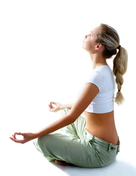 Attractive woman meditating in pose of lotus and looking at light