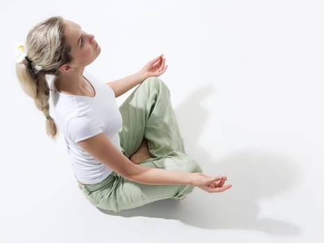 Above view of fit woman sitting and meditating