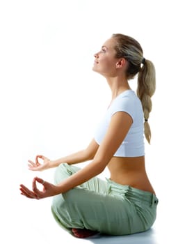 Profile of woman meditating in pose of lotus in isolation