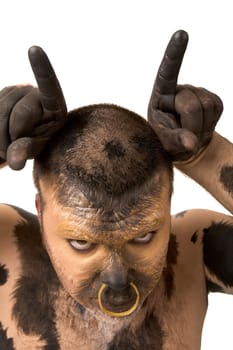 Painted man showing bull horns looking at camera on white background
