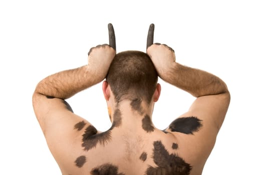 Rear view of young man with painted spots showing horns on white background