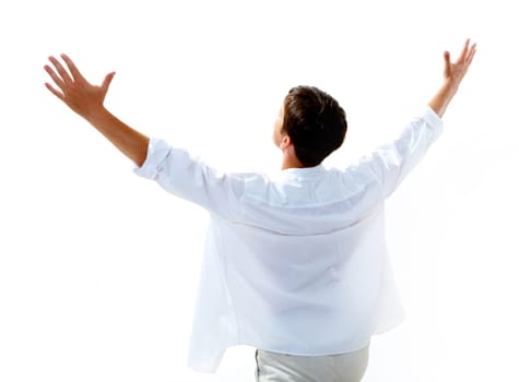 Back view of happy young man raising his arms enjoying life