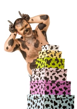 Portrait of happy man expressing himself as bull standing by heap of giftboxes