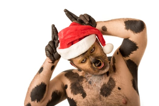Photo of funny man with Santa cap on head showing horns and saying moo
