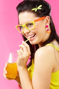 Portrait of beautiful woman drinking orange fizzy water