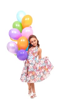 Portrait of happy girl with colorful balloons at birthday party