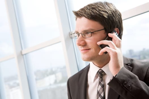 Portrait of confident leader talking by mobile phone