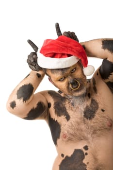 Portrait of bodypainted man wearing Santa cap and showing horns