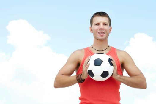 Portrait of a young man holding football ball