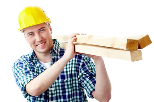 Portrait of a cheerful worker in helmet carrying lumber