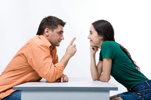 Smart man pointing upwards while explaining something to smiling girl