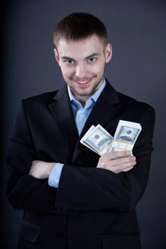 Portrait of confident businessman with dollars