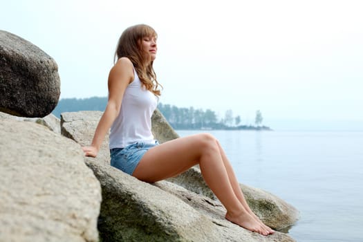 Portrait of pretty young lady having rest by the seaside