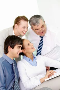 Portrait of several colleagues sitting in office and working