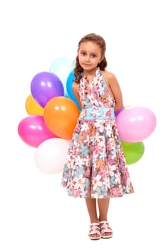 Portrait of happy girl with colorful balloons looking at camera
