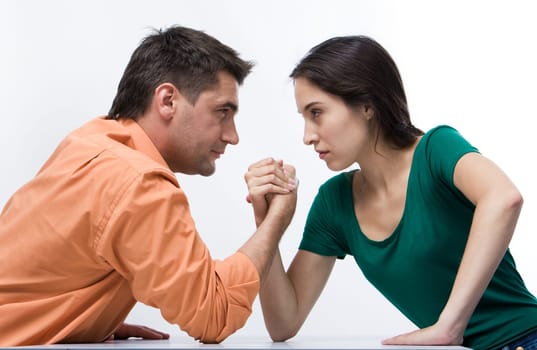 Man and woman doing arm wrestling showing their displeasure