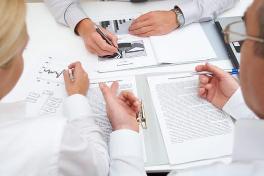 Image of workteam working with documents at business meeting