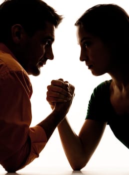 Close-up of dark figures of man and woman having struggle