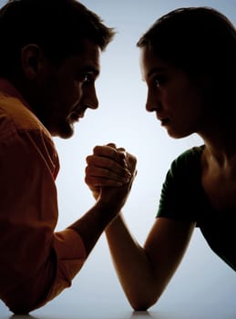 Close-up of dark figures of man and woman having struggle