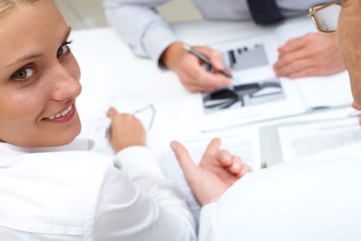 Image of pretty employee looking aside during conversation