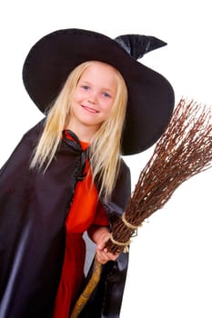 Portrait of girl in witch costume looking at camera
