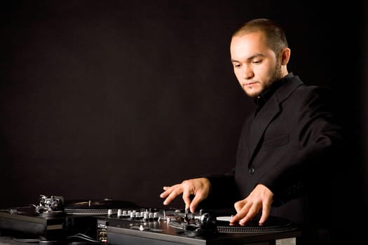 Portrait of handsome man with his hands on vynil records