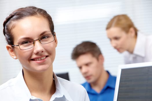 Portrait of smiling businesswoman with glasses on the background of people
