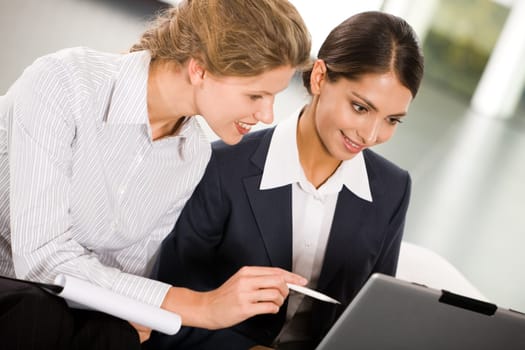 Portrait of two smiling business women working together