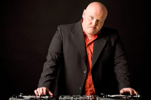 Portrait of big man with his hands on vynil records