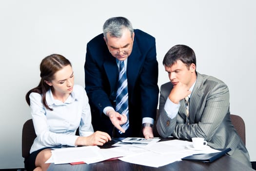 Image of confident boss giving instructions to his colleagues