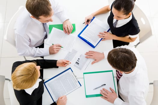 Above view of business team brainstorming while discussing new plans