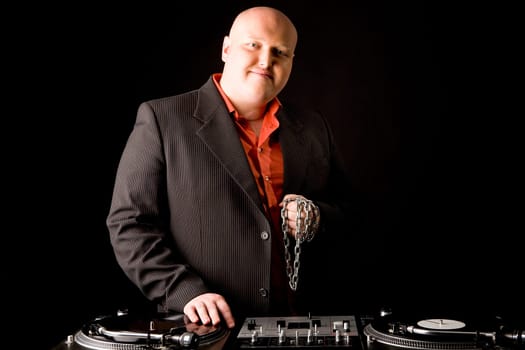 Portrait of big man looking at camera with his hand on vynil record