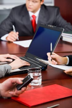 Break during conference: businesses people are engaged by their affairs