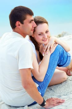 Peaceful couple enjoying summer vacation on sandy shore