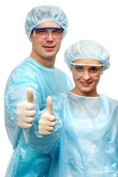 Two surgeons showing thumbs and smiling isolated on white