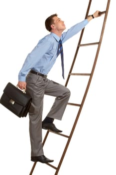 Portrait of businessman with briefcase climbing on staircase